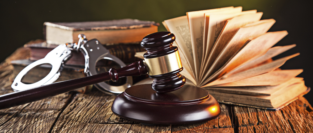 Wooden gavel and books on wooden table, law concept